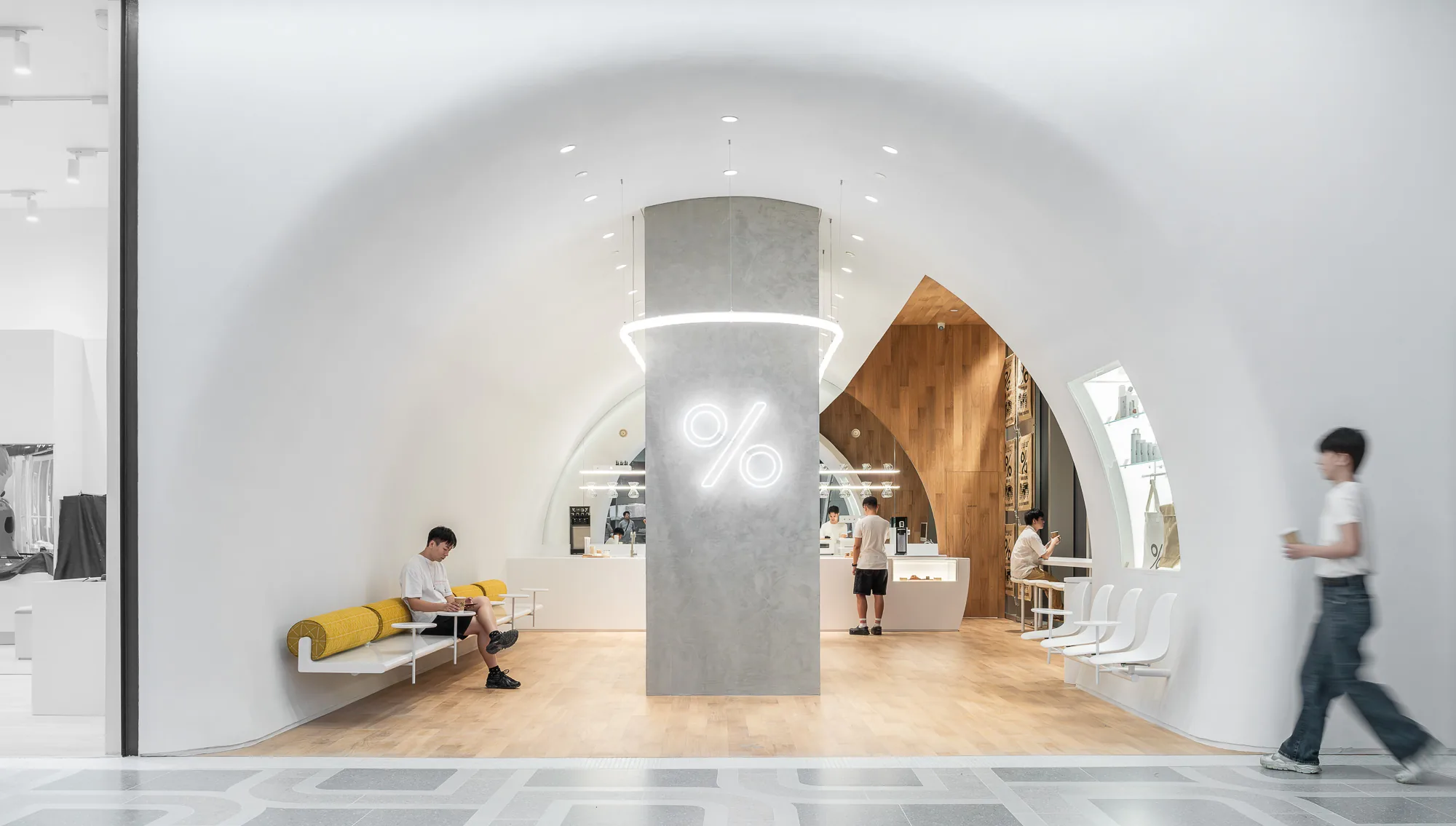 Inside the white arched space of % Arabica Dusit Central Park, Bangkok